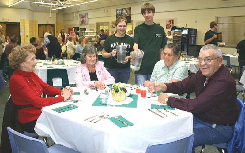 Bonny Eagle High School students, from left, Sara Clark and Matthew Hoyt, serve guests at Senior Citizens Night. Pictured, front from left, are Anita Cornish, Hollis; Lloma Raychard, Buxton; and Paul and Nellie Hanson, Standish.