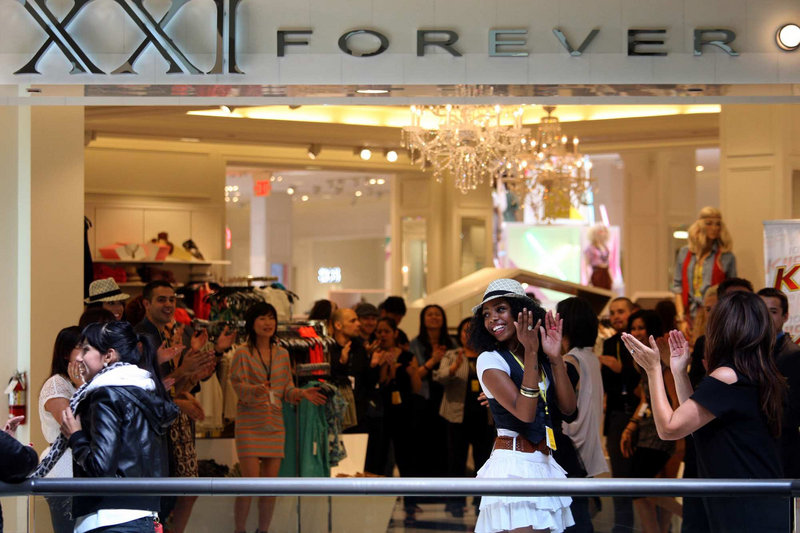 Employees of Forever 21 get into the spirit at the opening of the retailer’s 45,000-square-foot store last month in the Beverly Center in Los Angeles. The company is expected to open 70 new stores worldwide this year.