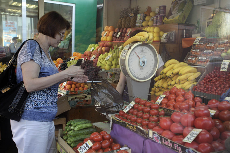 A woman shops at a market in Moscow on Tuesday. An unprecedented outbreak of bacterial infections linked to contaminated produce claimed two more lives in Europe on Tuesday, and Russia banned imports of cucumbers, tomatoes and lettuce.