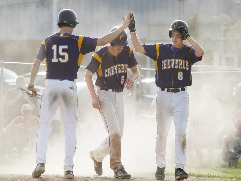 Louie DiStasio, left, Peter Gwilym, center, and Tyler Flaherty of Cheverus celebrate Tuesday after Gwilym scored on a sacrifice fly by Flaherty in the eighth inning of the 6-2 victory against Westbrook that gave the Stags the top seed in the Western Class A tourney.