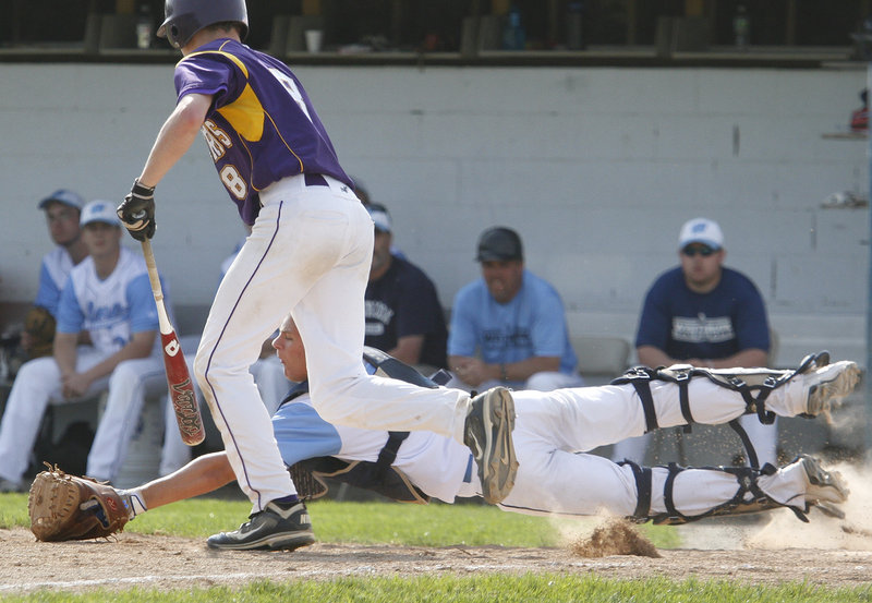 Westbrook catcher Kyle Heath dives Tuesday to snag a bunt by Tyler Flaherty of Cheverus in the fourth inning of Cheverus' 6-2 victory in eight innings at Olmsted Field. Heath made the catch, then threw out a runner at second base to complete a double play.