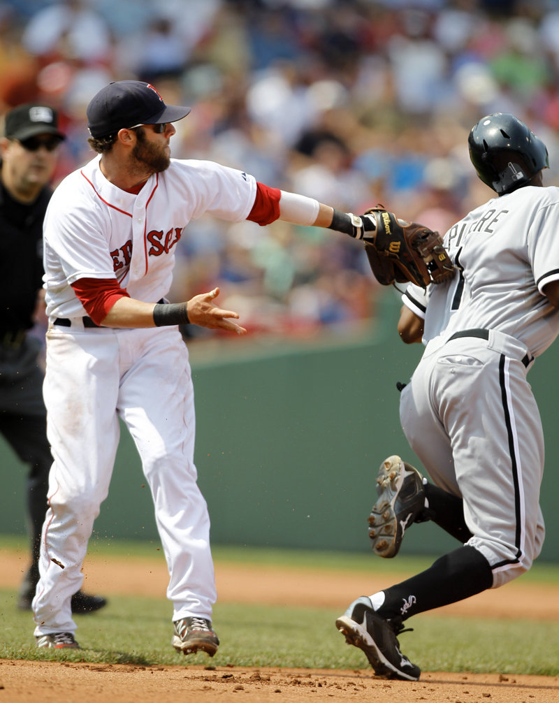 Dustin Pedroia of the Red Sox reaches to tag Juan Pierre of the Chicago White Sox, who stole second in the fifth inning of Chicago’s 7-4 win Wednesday at Fenway Park.