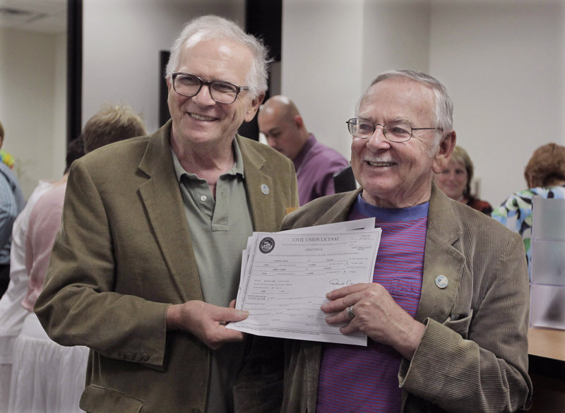 Patrick Bora, 73, left, and his partner Jim Darby, 79, show off their civil union license at the Cook County Office of Vital Records Wednesday in Chicago. The couple arrived early in the morning to be in line as Illinois’ new civil union law took effect.