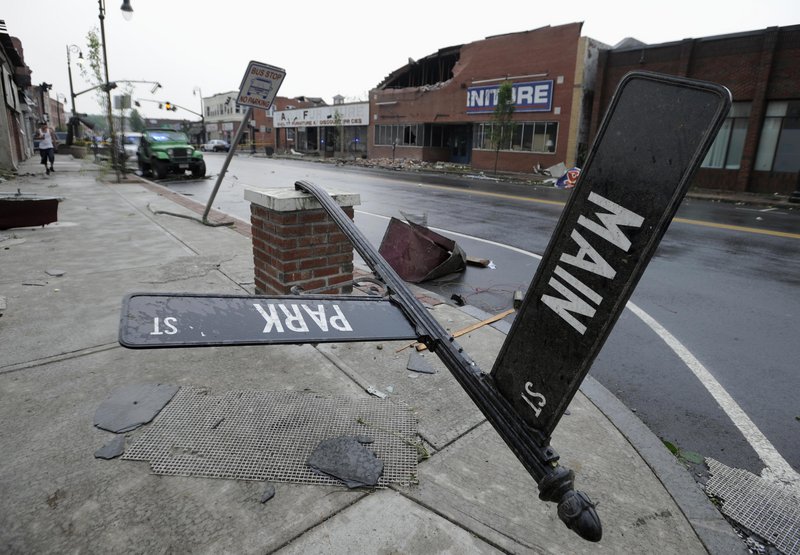 A toppled street sign and a damaged brick building attest to the severity of the winds that hit Springfield on Wednesday. Dozens of injuries were reported. State police received numerous calls about tornado sightings, and power outages hit at least 48,000 customers.
