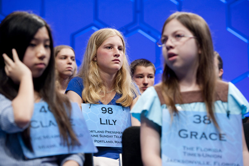 Maine’s Lily Jordan, No. 98 in the National Spelling Bee, is surrounded by fellow competitors during the semifinals Thursday at the Gaylord National Resort and Convention Center in National Harbor, Md.