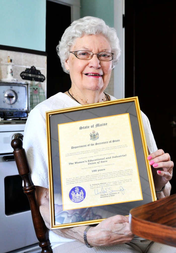 Herberta Harriman holds a plaque marking the 100th anniversary of the Women's Educational and Industrial Union of Saco.