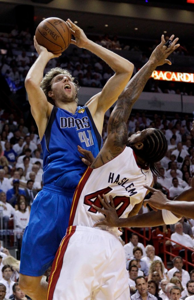 Dirk Nowitzki of the Mavericks puts up a shot over Udonis Haslem of the Heat during Game 2 of the NBA finals Thursday night. Dallas tied the series with a 95-93 win.
