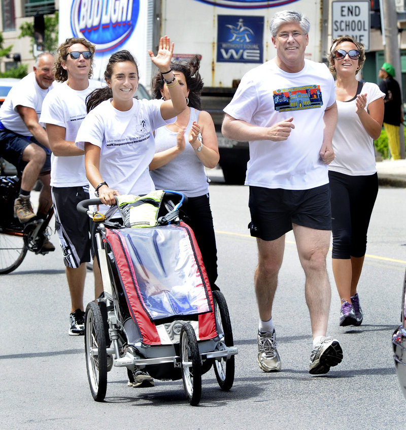 Zoe Romano waves as she and Portland Mayor Nick Mavodones take a ceremonial run Friday from Longfellow Square to the Portland Boys & Girls Clubs of Southern Maine on Cumberland Avenue. June 3 was proclaimed Zoe Goes Running Day. She raised more than $13,000 for Boys & Girls Clubs nationwide.