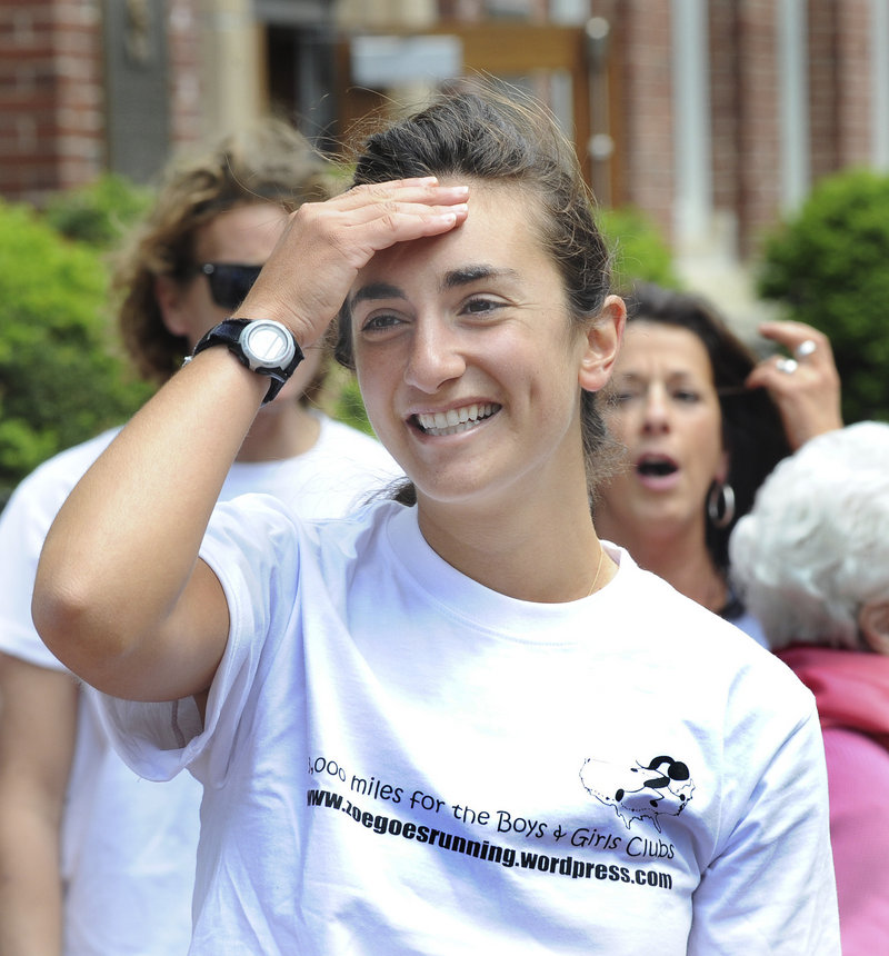 Zoe Romano reacts as Portland High School students line the front of PHS to welcome her after her ceremonial run Friday.