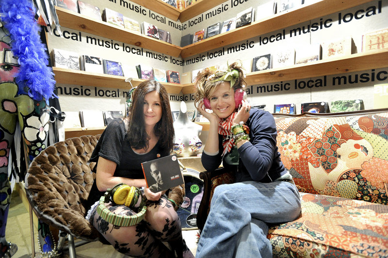 Robin Ivy, left, morning show host on WCYY Radio, has helped Meredith Alex promote southern Maine musicians at Alex's Commercial Street shop.