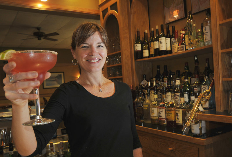 Sarah Lane, one of the owners of Lucas on 9, serves up a black raspberry margarita.