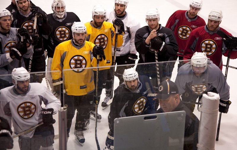 Bruins Coach Claude Julien goes over a few points – about the power play, perhaps? – during practice on Friday in Vancouver, British Columbia. The Canucks took a 1-0 series lead with a last-minute goal Wednesday night.