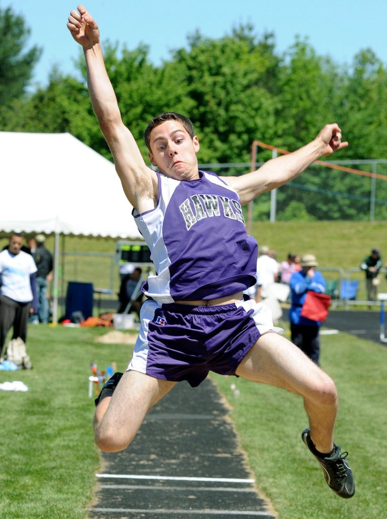 Marshwood’s David Mick stretches out for a long jump of 19 feet, 3 3⁄4 inches Saturday during the Class A state championships at Windham High. Sanford’s Alex Shain won the event with a jump of 21-2.