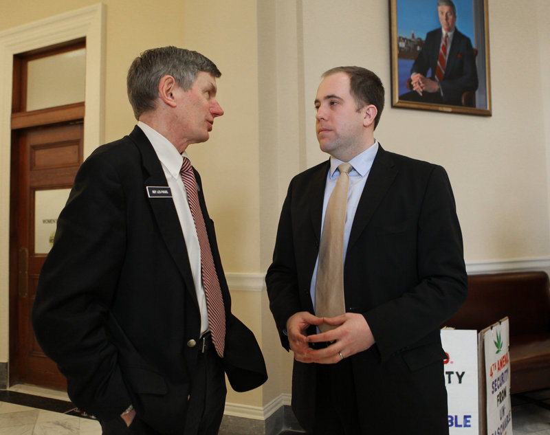 Rep. Les Fossel, R-Alna, left, speaks with Sen. Seth Goodall, D-Richmond, at the State House on Feb. 10. Centrist Democrats and Republicans are joining forces to make their voices heard and to forge a compromise on partisan issues in Augusta.