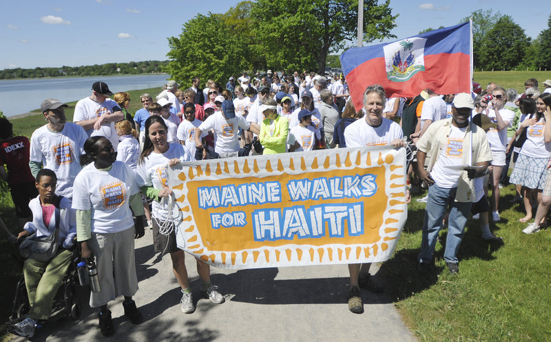 Walkers get set to walk around Back Cove as part of Maine Walks for Haiti, a fundraising event to benefit the Konbit Sante Cap-Haitien Health Partnership on Saturday. Holding the sign out front are Lisa Merchant and John Shoos, who serves on the board for Konbit Sante.