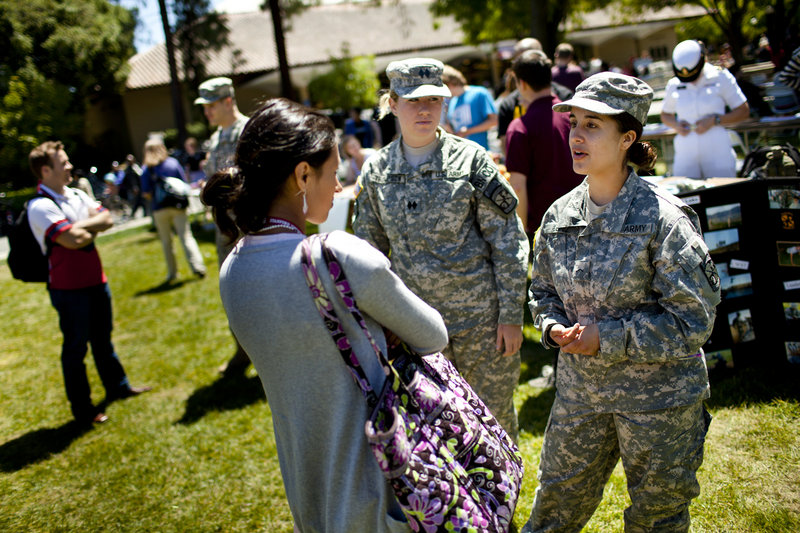 Kaitlyn Benitez-Strine, 17, left, talks about the military with ROTC representatives Anna Thompson, 22, center, and Isabel Lopez, 18, at Stanford University in California in April.