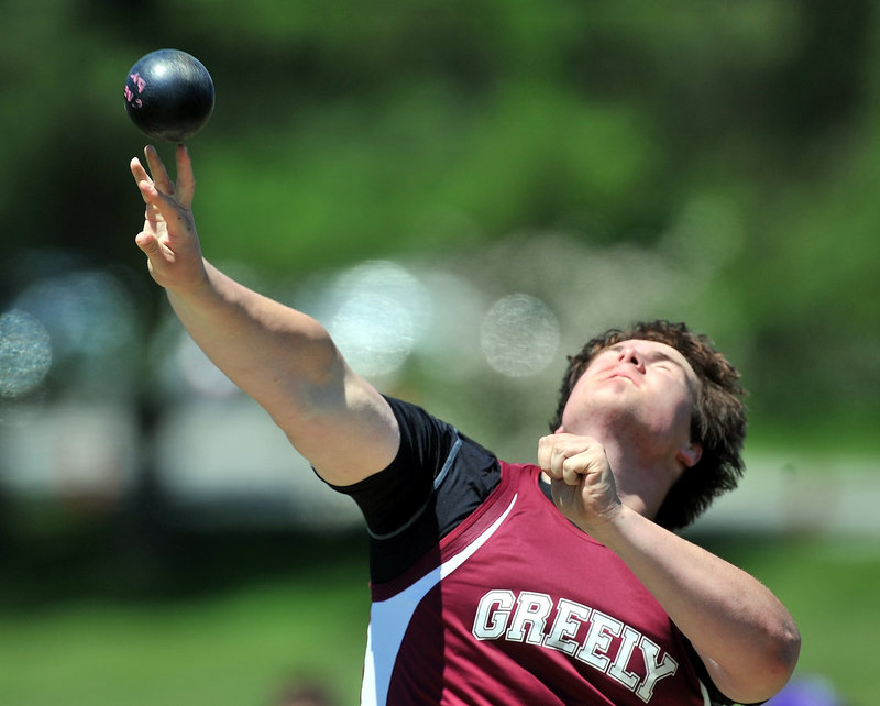 Jack Fellows of Greely gives it his all in the Class B shot put. Fellows' best throw gave him a runner-up finish to teammate Michael Burgess.