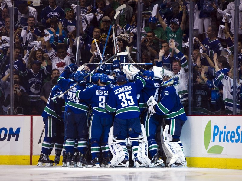 Vancouver players celebrate after Alex Burrows scored 11 seconds into overtime as the Canucks beat the Bruins 3-2 in Game 2 of the Stanley Cup finals.