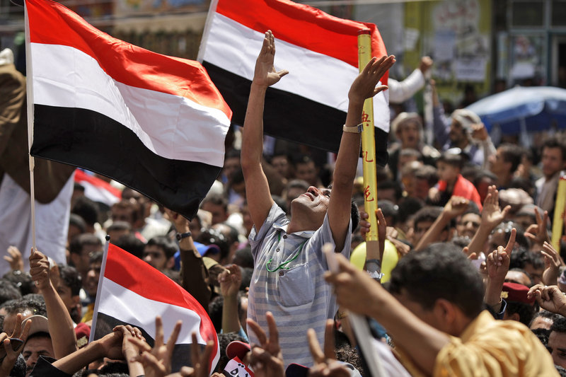 An anti-government protester, center, celebrates with other demonstrators the departure of President Ali Abdullah Saleh to Saudi Arabia in San'a, Yemen, on Sunday.