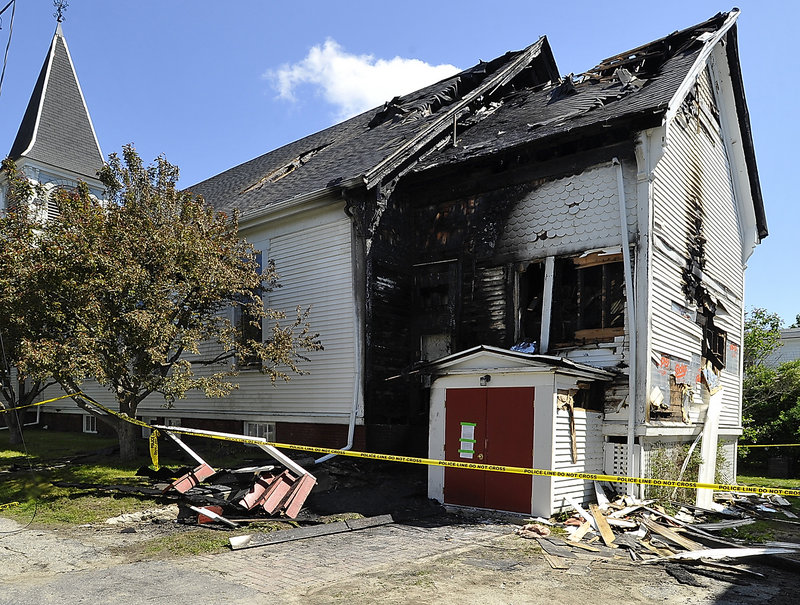 Extensive damage is evident at the back of the Unitarian Universalist Church in Brunswick after a fire broke out Monday. The blaze apparently started in old, faulty wiring at the base of the two-story extension in the back of the building.