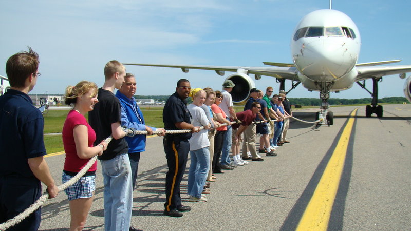 Participants in a "Plane Pull" to benefit the MS Society.