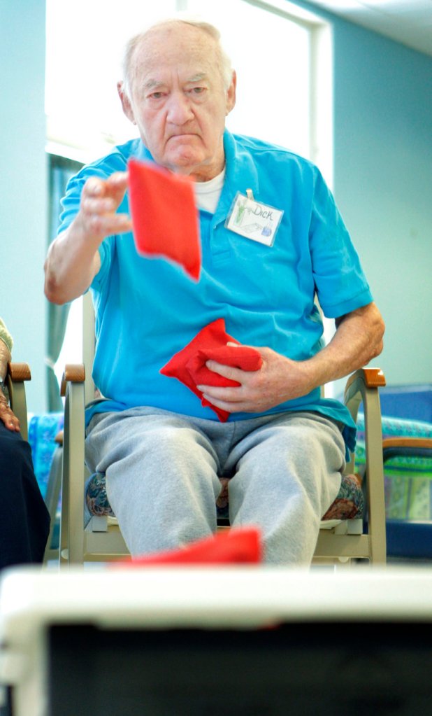 Dick Potvin throws a beanbag during an activity at the Truslow Adult Day Center in Saco on Monday.