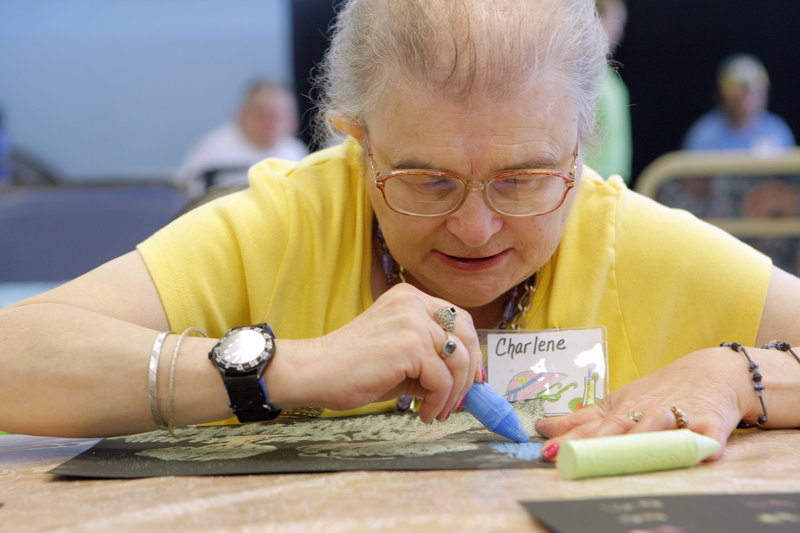 Charlene Gardner works on a drawing at the Truslow Adult Day Center in Saco on Monday. The center charges $14 an hour, which is sometimes reduced or covered by insurance plans.