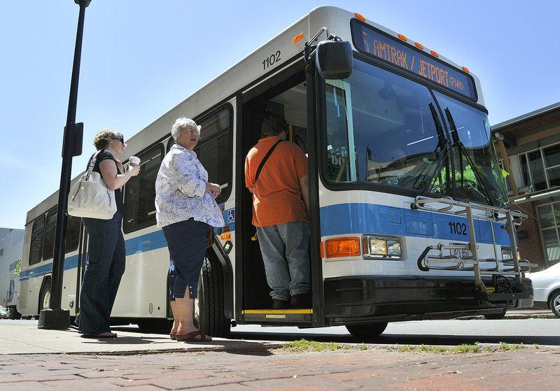 Passengers board a new Metro bus Wednesday on Elm Street in Portland. Most of the funding for the clean-diesel buses came from the federal stimulus package.