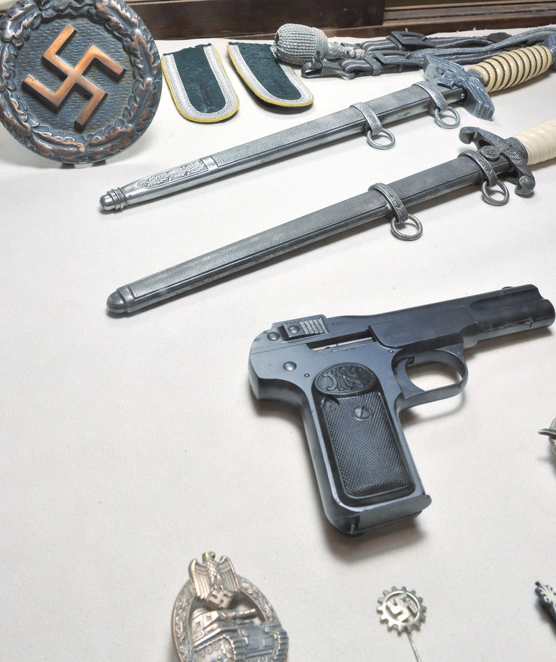 World War II weapons and insignia are displayed at the new museum.