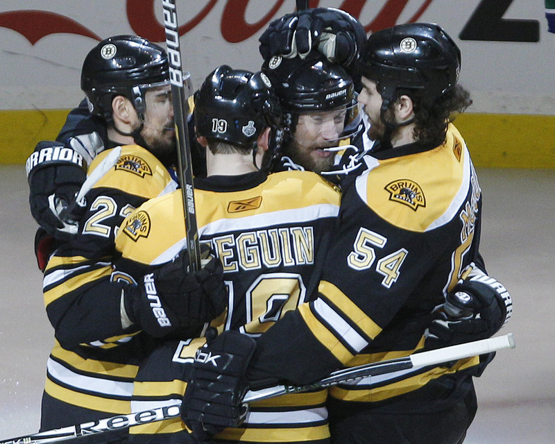 Michael Ryder, second from right, is congratulated after scoring a second-period goal in Boston’s 4-0 win over Vancouver that tied the Stanley Cup finals.