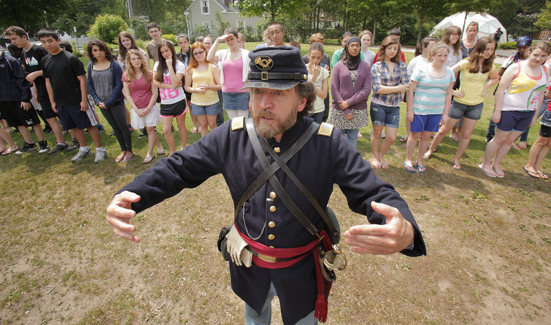 Glen Lawson, commander of Company A of the 3rd Maine Regiment Volunteer Infantry re-enactment group, shows eighth-graders at Lincoln Middle School in Portland how to line up in a battle formation on Thursday. The students have been studying the Civil War for three weeks.