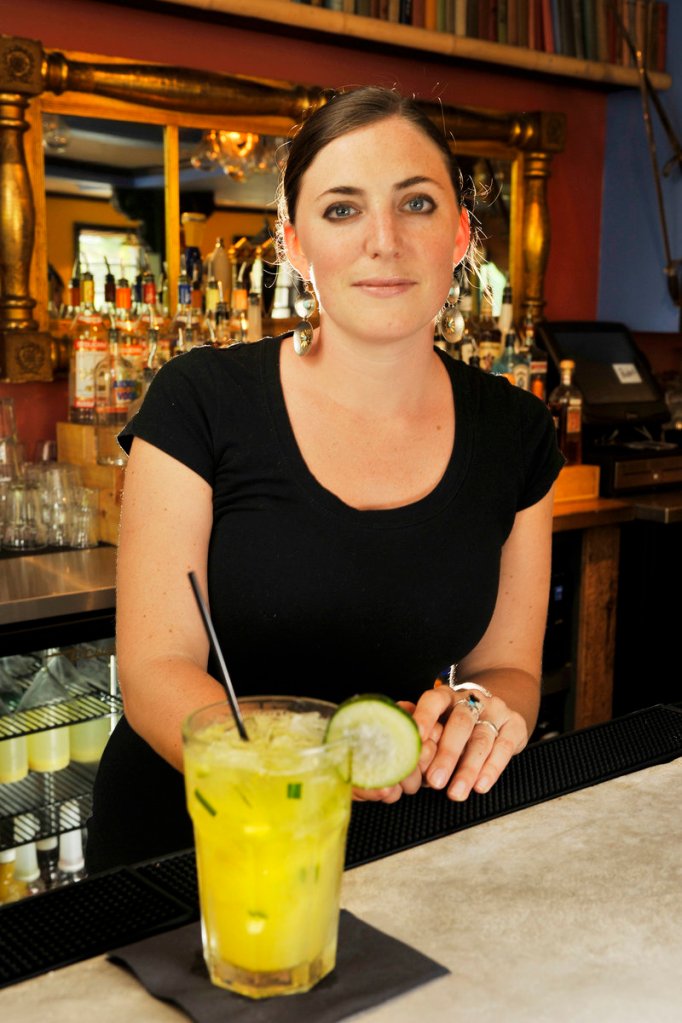 Bartender Sara Robinson with one of the signature margaritas at Pedro's – "El Pepino," a cucumber margarita.
