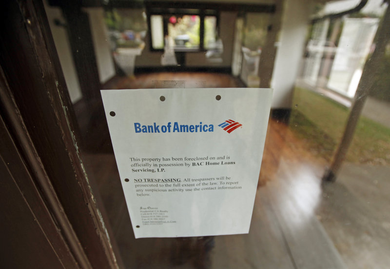 A Bank of America foreclosure notice is seen in the front window of a home in Los Angeles. The Obama administration says that the three largest U.S. lenders haven’t helped enough people lower their mortgage payments to stay in their homes.