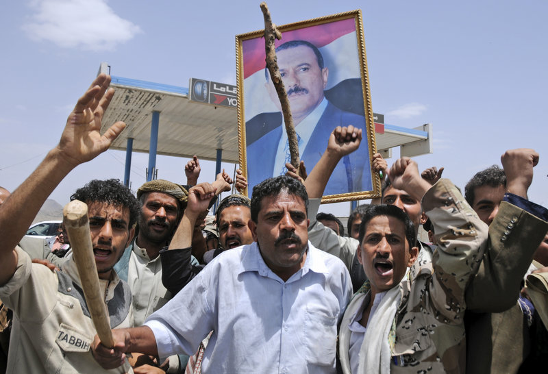 Supporters of Yemeni President Ali Abdullah Saleh hold up his portrait as they celebrate news that Saleh’s health is stable after being taken to Saudi Arabia to receive treatment for wounds he suffered in a rocket attack on his compound.
