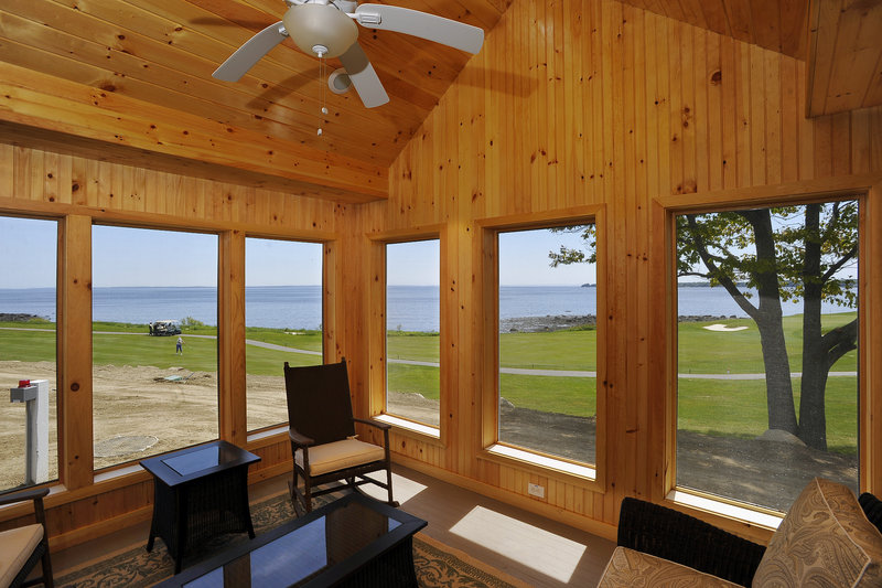 This screened-in sitting room in one of the new cottages overlooks the golf course on the ocean at the Samoset Resort in Rockport.
