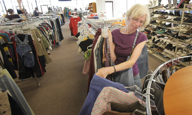 Sarah Harriman of Bath looks over clothes at the Catholic Charities Thrift Store in Portland on Tuesday. “I’ve been thrift store shopping since the ’70s, and this is a good one ... clean and neat with good-quality merchandise,” she said.