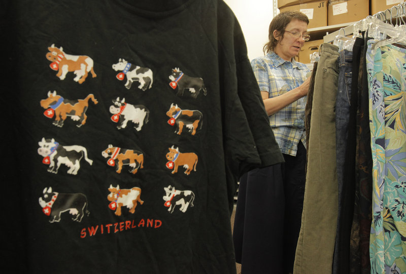 Francine Spangler, a volunteer at the Catholic Charities Thrift Store in Union Station Plaza on St. John Street in Portland, prices pants Tuesday.