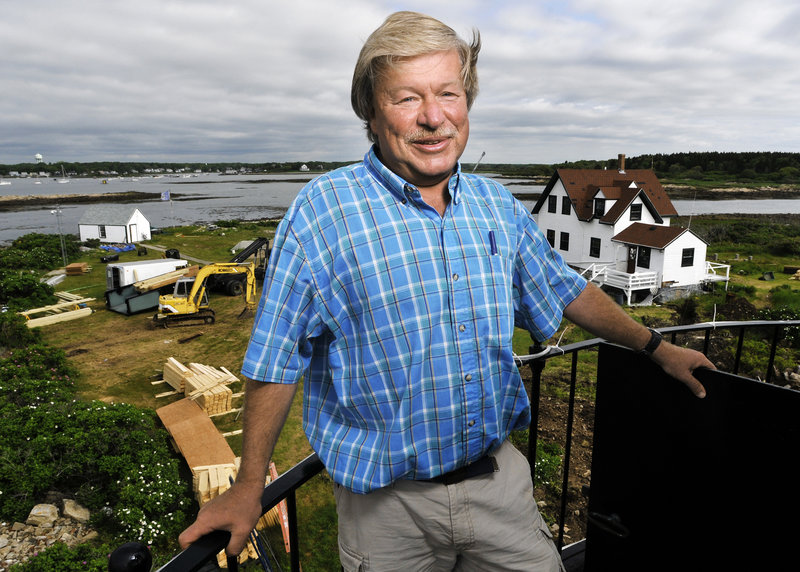 Scott Dombrowski stands atop the lighthouse on Goat Island, where he has been caretaker for 19 years. After the station renovation is completed in September, a $2 million endowment will be created to preserve the site for future generations.