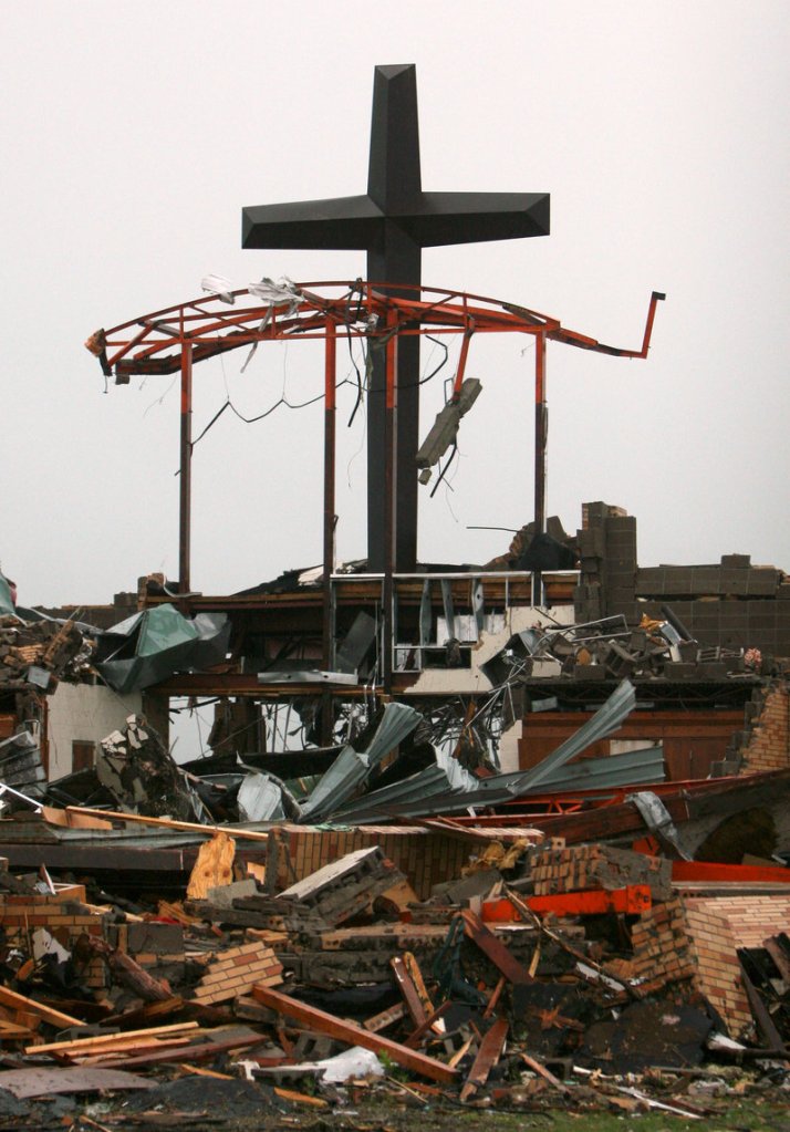 A cross rises above the rubble of St. Mary’s Catholic Church in Joplin, Mo., on May 23 after a tornado devastated the town. A majority of white evangelicals – 59 percent – say natural disasters are a sign from God.