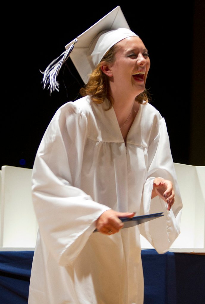 Westbrook High graduate Katelyn Benson laughs after her diploma was dropped during its presentation.