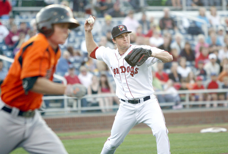 Sea Dogs starter Chris Balcom-Miller throws to first base for an out after fielding a ground ball Friday night during a game against the Bowie Baysox at Hadlock Field. Bowie scored six runs in the first inning and won, 7-3.
