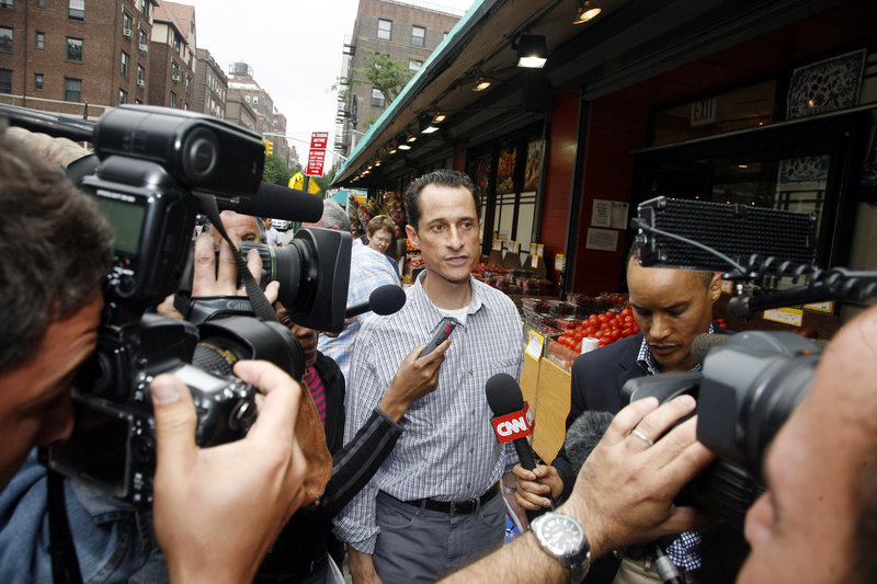 Rep. Anthony Weiner, D-N.Y., is questioned by the media near his home in Queens on Saturday. Party leaders called on him to resign for his role in a sex texting scandal.