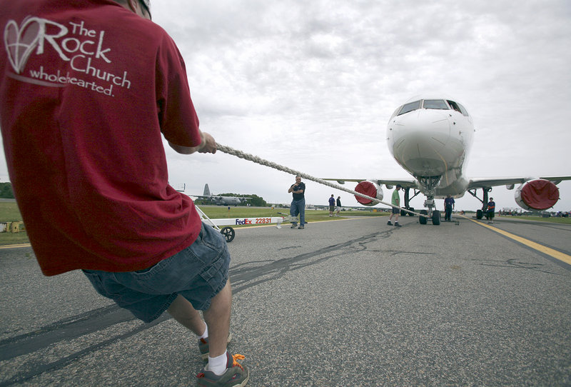 A competitor pulls a Boeing 757 in the Multiple Sclerosis Society of Maine “Plane Pull” event during the expo Saturday.