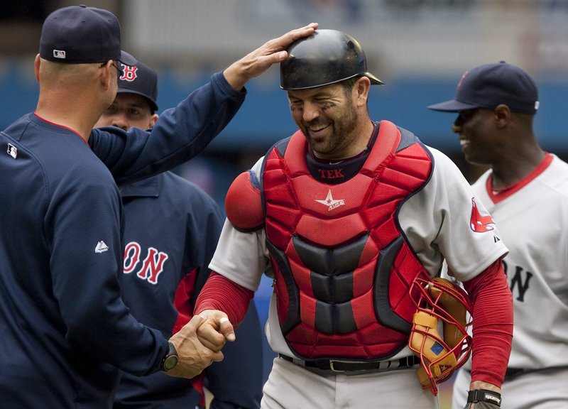 Jason Varitek laughs with Manager Terry Francona following Boston’s 16-4 win over Toronto on Saturday. Varitek had a three-run home run as every Boston starter drove in at least one run.