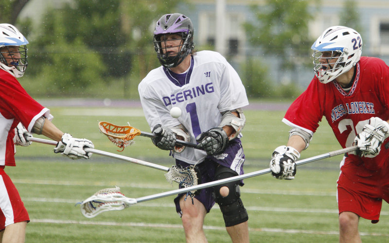 Carleton Allen, who scored three goals for Deering, looks to control the ball while sandwiched by Carl Smith, left, and Ryan McLellan of Messalonskee.