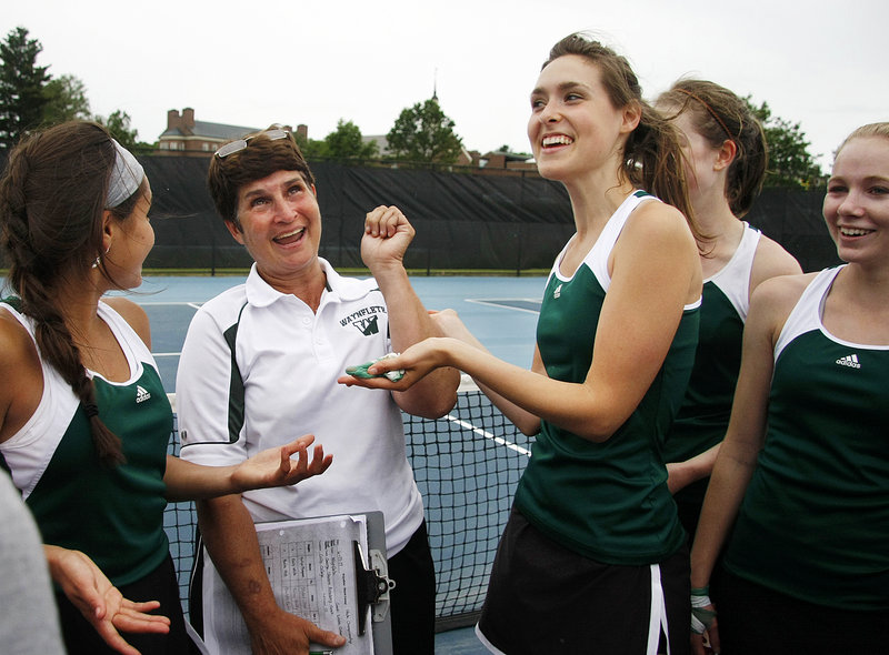 Waynflete Coach Linda Cohen, second from left, celebrates with team members, from left, Elena Britos, Maddie High, Hilary Niles and Emily White after winning the Class C state title Saturday at Colby College in Waterville.