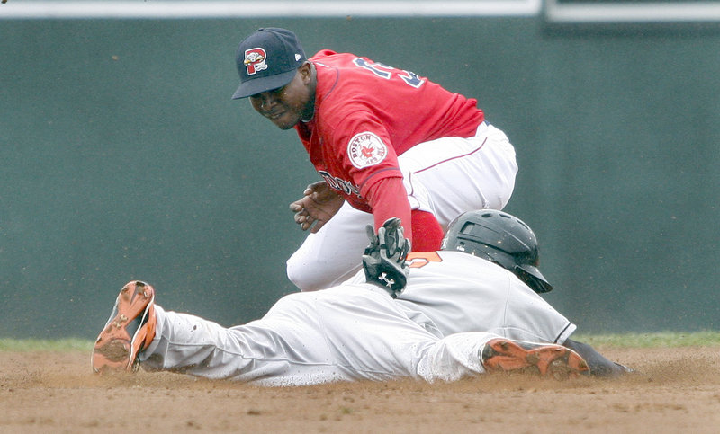 Sea Dogs second baseman Oscar Tejeda tags out Bowie's Xavier Avery, who was trying to stretch a single into a double. Portland lost 10-7 in the opener of a scheduled doubleheader, and the second game was postponed.