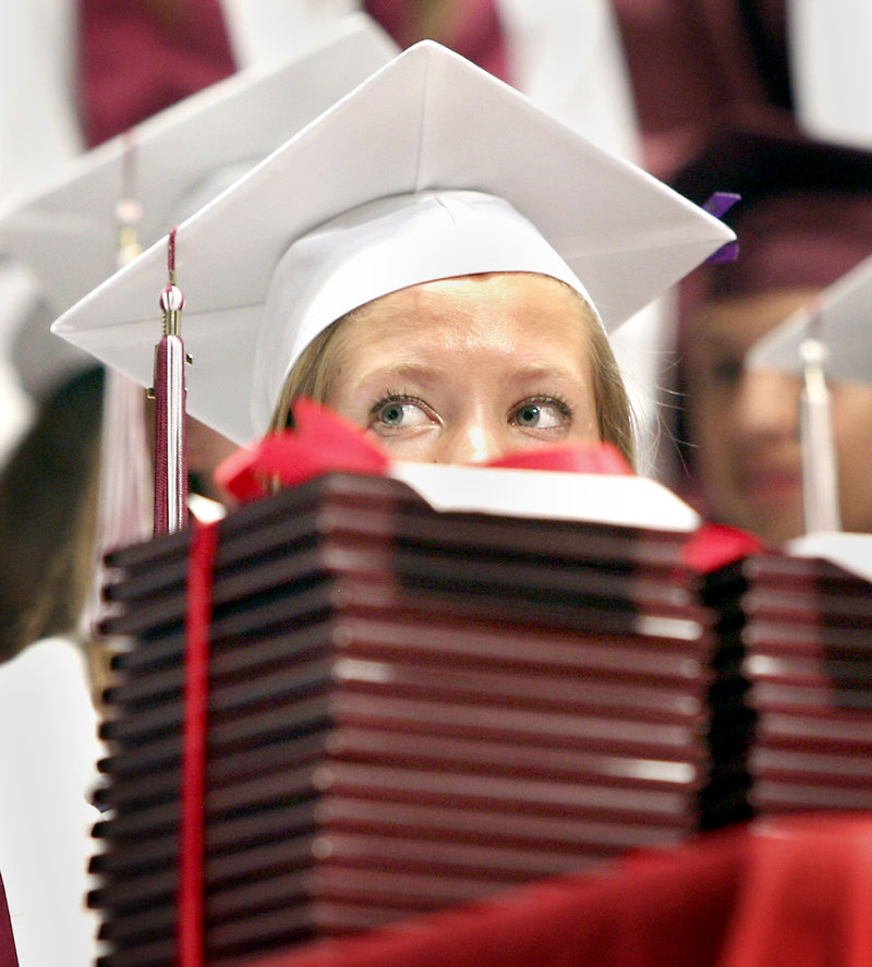 Kelly Devoe looks on as her Gorham High School classmates receive their diplomas.