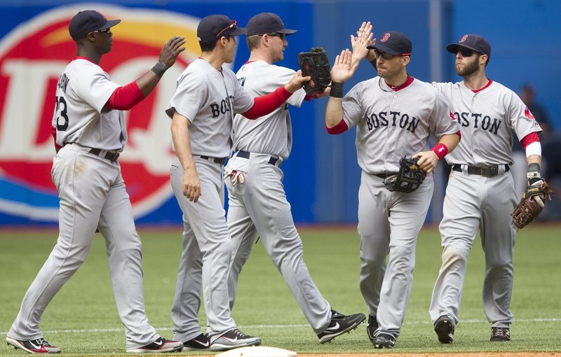 Red Sox Mike Cameron, Jacoby Ellsbury, J.D. Drew, Marco Scutaro and Dustin Pedroia celebrate their 14-1 win Sunday at Toronto. Boston swept the three-game series, outscoring the Jays, 35-6. David Ortiz and Kevin Youkilis were the big hitters Sunday. They each had a homer and four RBI.