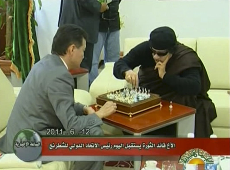Libyan leader Moammar Gadhafi, right, plays chess with Kirsan Ilyumzhinov, the president of the World Chess Federation, on Sunday in Libya. It was unclear why Ilyumzhinov was in the country, but he told reporters that Gadhafi told him he has no plans to leave.